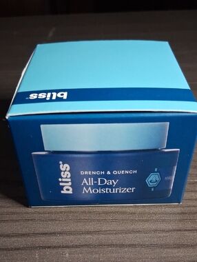 Bliss All-Day Moisturizer in light blue and deep blue packaging